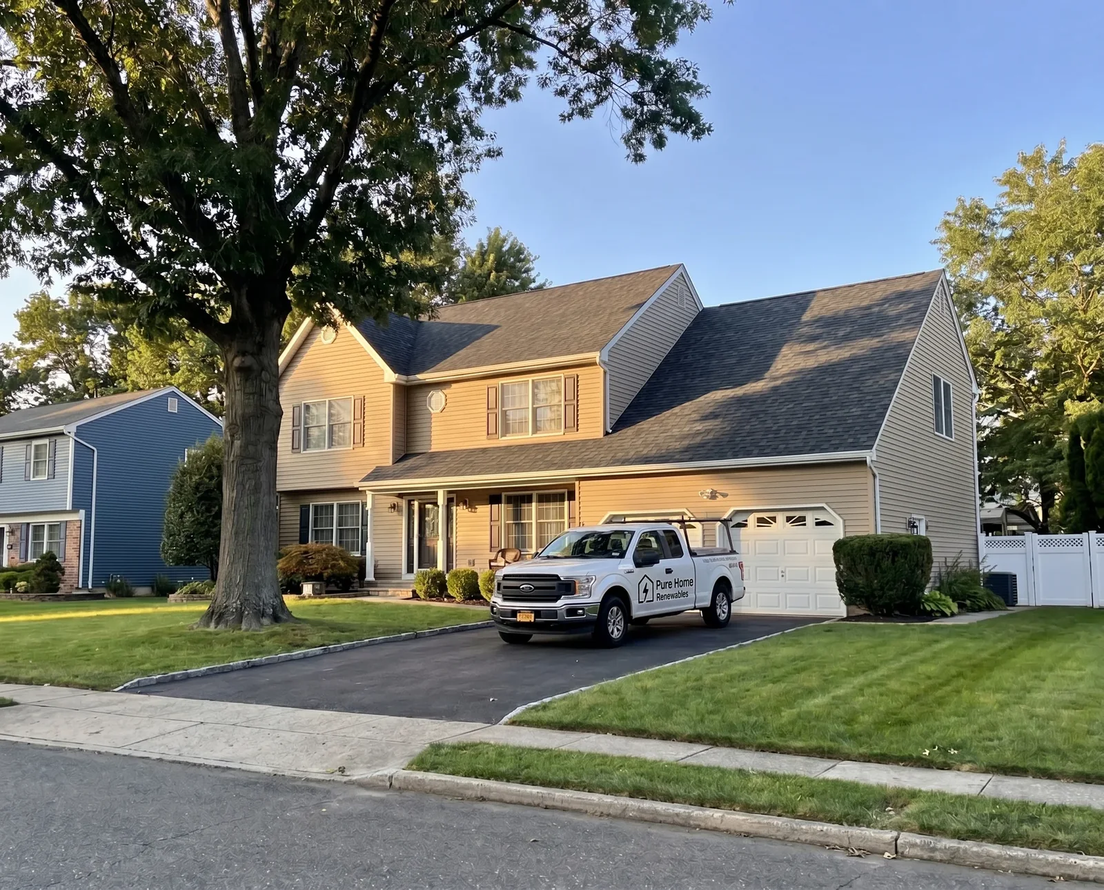 Two-story house with a white pickup truck parked in the driveway